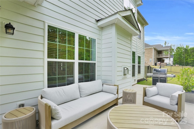 view of patio / terrace with fence, grilling area, and outdoor lounge area