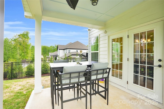 view of patio featuring fence, outdoor dining space, and french doors