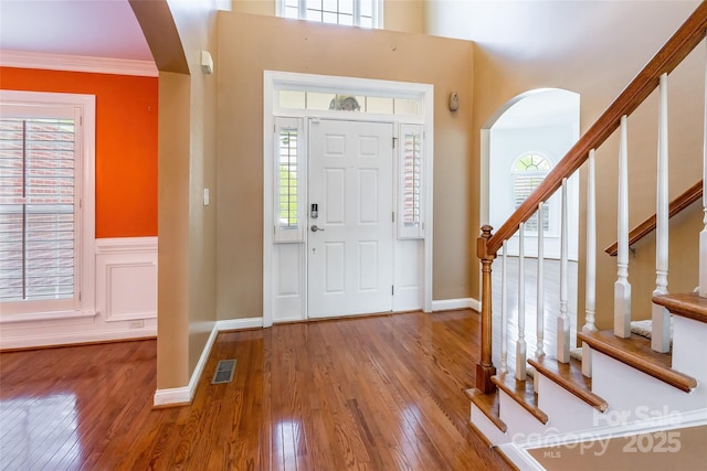 4333 Sawmill Trace Dr, Charlotte, NC 28213 - entrance foyer featuring visible vents, stairway, arched walkways, and wood finished floors