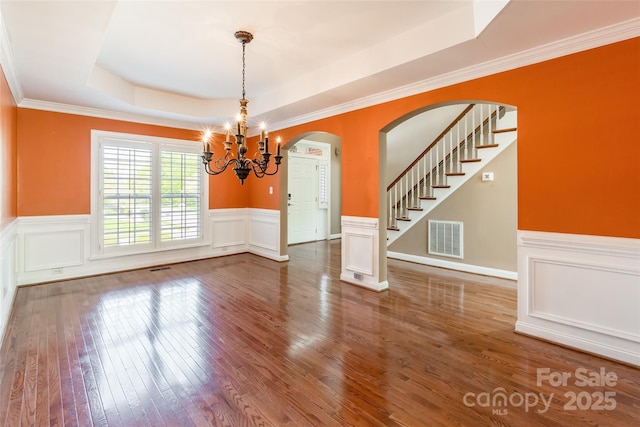 4333 Sawmill Trace Dr, Charlotte, NC 28213 - unfurnished dining area with a tray ceiling, visible vents, a wainscoted wall, a chandelier, and wood-type flooring