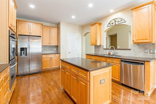 4333 Sawmill Trace Dr, Charlotte, NC 28213 - kitchen with backsplash, light wood-style floors, appliances with stainless steel finishes, arched walkways, and a sink