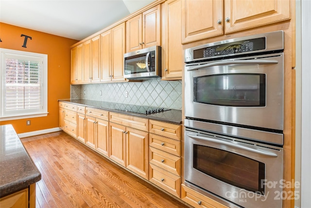 4333 Sawmill Trace Dr, Charlotte, NC 28213 - kitchen with baseboards, light wood-style floors, decorative backsplash, appliances with stainless steel finishes, and light brown cabinetry