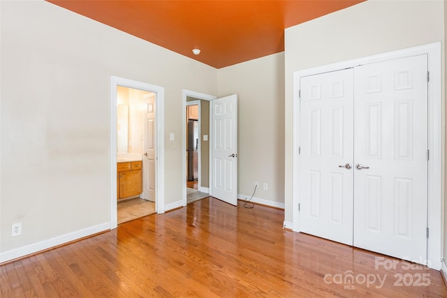4333 Sawmill Trace Dr, Charlotte, NC 28213 - unfurnished bedroom featuring a closet, baseboards, light wood finished floors, and ensuite bathroom