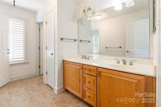 4333 Sawmill Trace Dr, Charlotte, NC 28213 - full bathroom with tile patterned floors, double vanity, a sink, and a notable chandelier