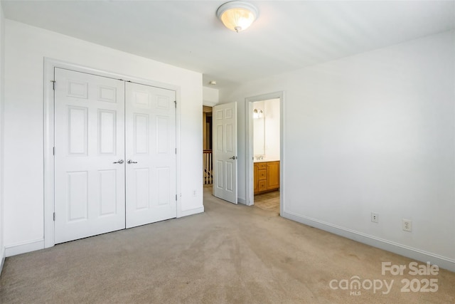 4333 Sawmill Trace Dr, Charlotte, NC 28213 - unfurnished bedroom featuring ensuite bath, a closet, baseboards, and light colored carpet