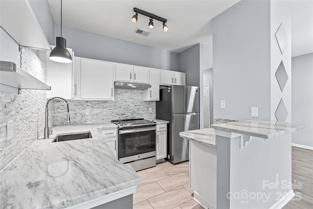 2059 Lennox Square Rd, Charlotte, NC 28210 - kitchen with appliances with stainless steel finishes, a sink, under cabinet range hood, light stone countertops, and backsplash