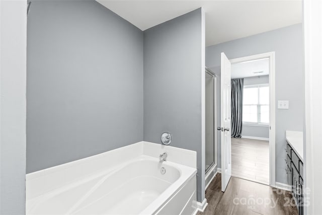 2059 Lennox Square Rd, Charlotte, NC 28210 - full bath with a bath, a stall shower, wood finished floors, vanity, and baseboards