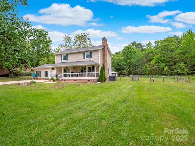 915 Gate Rd, Monroe, NC 28112 - back of property featuring a chimney, crawl space, a storage unit, a porch, and an outbuilding