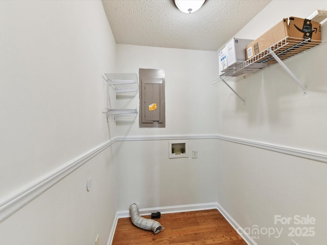 915 Gate Rd, Monroe, NC 28112 - washroom featuring electric panel, wood finished floors, a textured ceiling, washer hookup, and baseboards