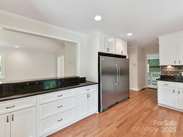 915 Gate Rd, Monroe, NC 28112 - kitchen featuring freestanding refrigerator, white cabinets, light wood-type flooring, decorative backsplash, and ornamental molding