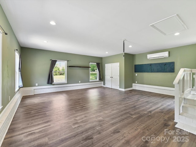915 Gate Rd, Monroe, NC 28112 - unfurnished living room with an AC wall unit, wood finished floors, baseboards, and recessed lighting