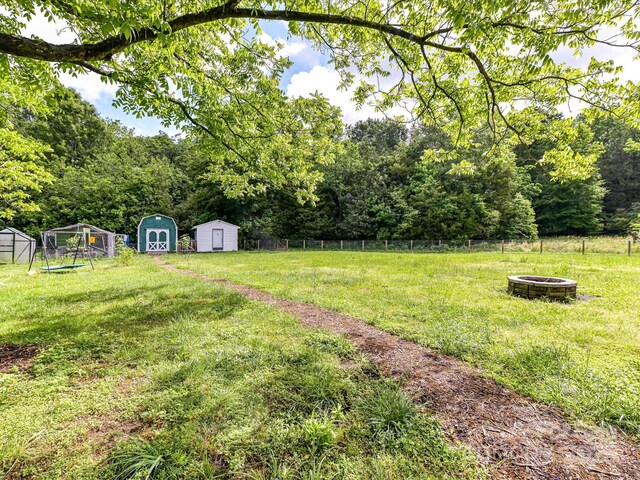 915 Gate Rd, Monroe, NC 28112 - view of yard with a shed, a fire pit, and an outbuilding