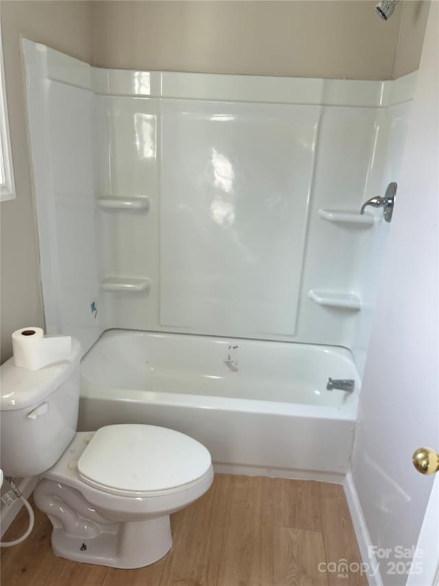 full bathroom with toilet, wood finished floors, and bathtub / shower combination