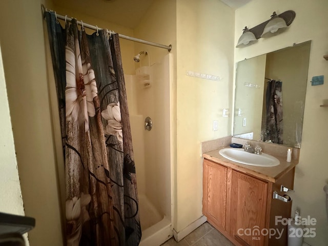 full bath featuring a stall shower, tile patterned floors, and vanity