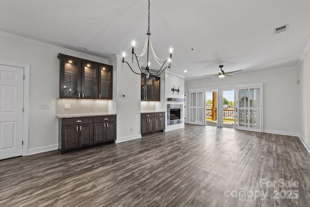 18700 Nautical Dr Unit 203, Cornelius, NC 28031 - unfurnished living room featuring crown molding, dark wood finished floors, a ceiling fan, a chandelier, and a fireplace