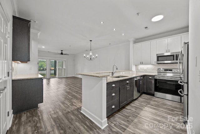18700 Nautical Dr Unit 203, Cornelius, NC 28031 - kitchen with stainless steel appliances, wood finished floors, tasteful backsplash, light stone counters, and open floor plan