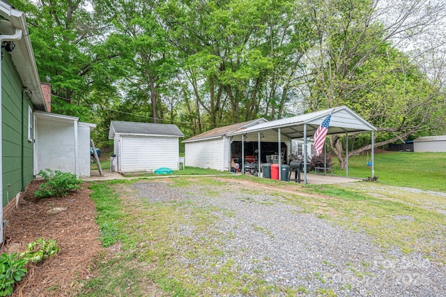 211 Hershel Lackey Rd, Lincolnton, NC 28092 - view of yard with a carport, an outbuilding, and a shed