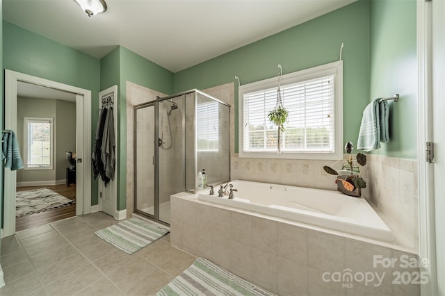 full bathroom featuring a shower stall, a garden tub, and tile patterned flooring