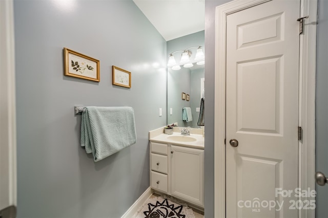 bathroom with baseboards and vanity