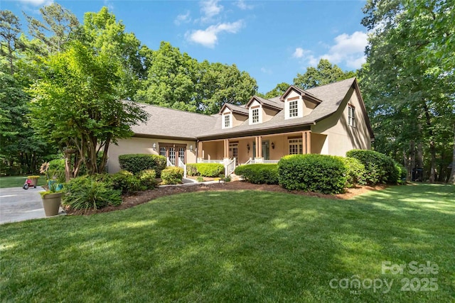 4925 Pageland Hwy, Monroe, NC 28112 - new england style home with a porch, a front lawn, and stucco siding