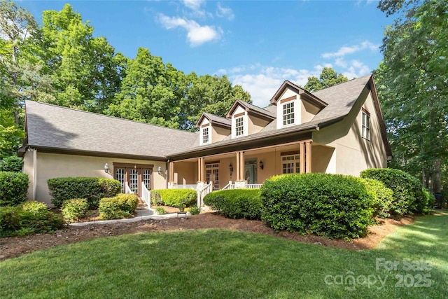 4925 Pageland Hwy, Monroe, NC 28112 - cape cod house featuring covered porch, stucco siding, and a front lawn