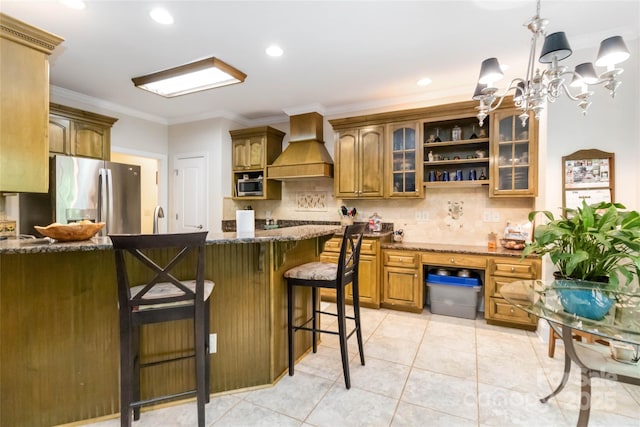 4925 Pageland Hwy, Monroe, NC 28112 - kitchen featuring a kitchen breakfast bar, premium range hood, backsplash, stainless steel refrigerator with ice dispenser, and glass insert cabinets