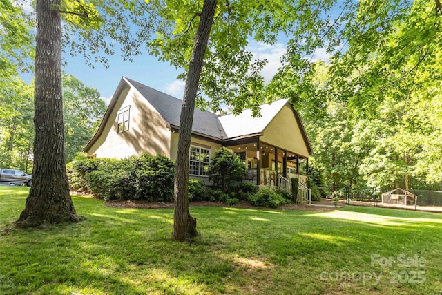 4925 Pageland Hwy, Monroe, NC 28112 - view of side of property featuring stucco siding, a yard, and a porch