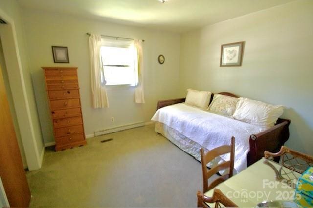 carpeted bedroom with baseboards and a baseboard heating unit
