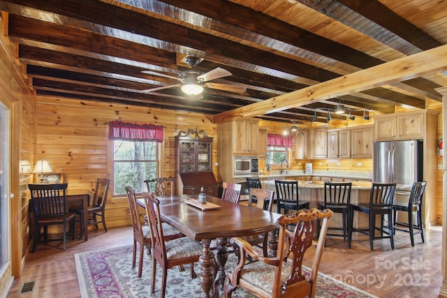 475 S Toe River Rd, Burnsville, NC 28714 - dining area featuring beam ceiling, a wealth of natural light, wood-type flooring, and visible vents