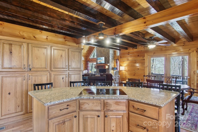 475 S Toe River Rd, Burnsville, NC 28714 - kitchen with light wood-style floors, a healthy amount of sunlight, beamed ceiling, and black electric cooktop