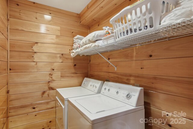 475 S Toe River Rd, Burnsville, NC 28714 - clothes washing area with independent washer and dryer, laundry area, and wood walls