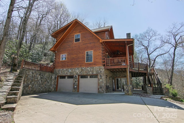 475 S Toe River Rd, Burnsville, NC 28714 - view of side of home featuring stairway, log siding, an attached garage, a chimney, and concrete driveway