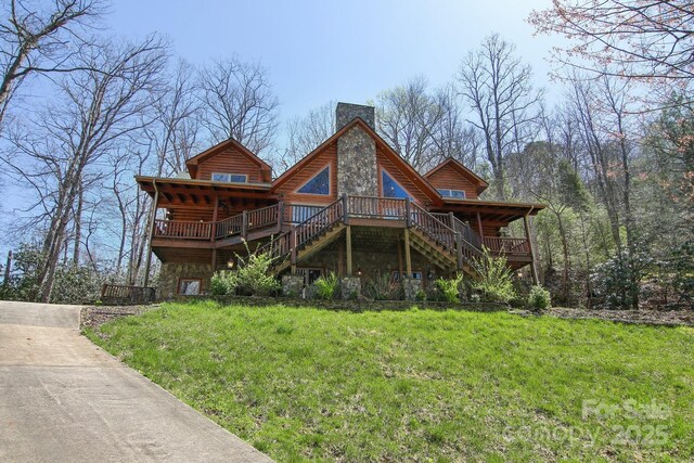 475 S Toe River Rd, Burnsville, NC 28714 - rear view of property featuring log siding, a chimney, stone siding, stairs, and a lawn