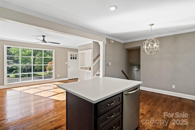 kitchen featuring baseboards, open floor plan, crown molding, ceiling fan, and hanging light fixtures