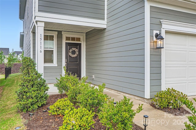 view of exterior entry featuring a garage