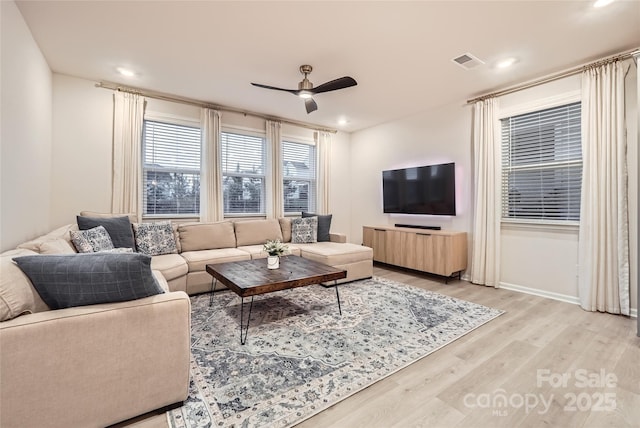 living room with visible vents, a ceiling fan, light wood finished floors, and recessed lighting
