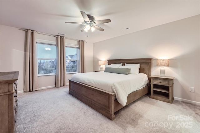 bedroom with visible vents, a ceiling fan, baseboards, and light carpet