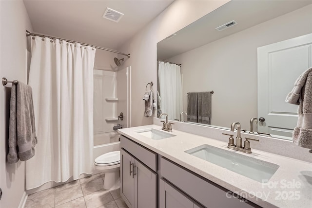 bathroom with toilet, visible vents, and a sink