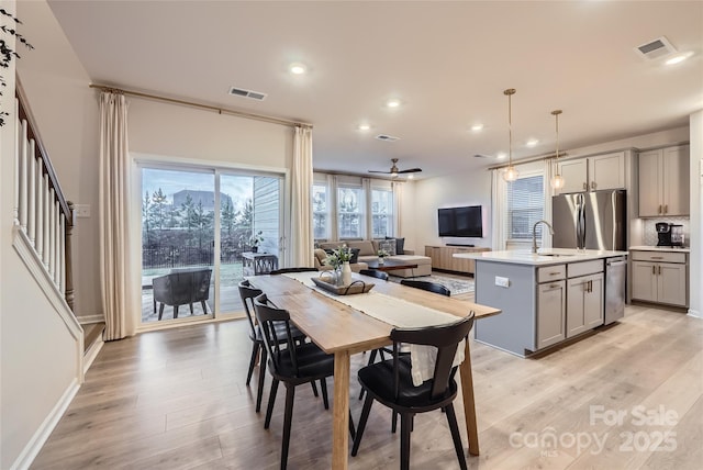 dining room with stairs, recessed lighting, visible vents, and light wood finished floors