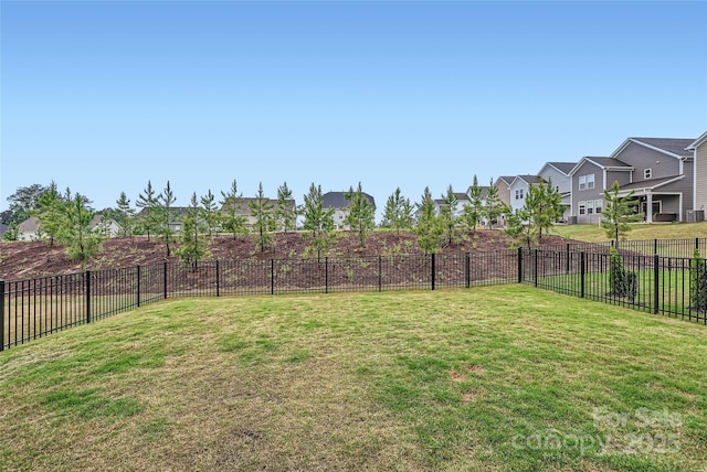 view of yard featuring fence and a residential view