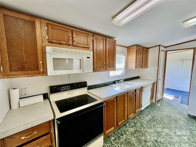 105 Branson Dr, Olin, NC 28660 - kitchen with a sink, light countertops, white appliances, and brown cabinets