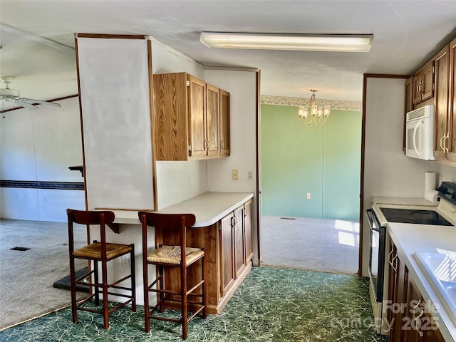 105 Branson Dr, Olin, NC 28660 - kitchen with white microwave, dark colored carpet, electric range, and ceiling fan with notable chandelier