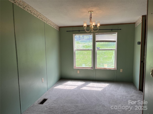 105 Branson Dr, Olin, NC 28660 - carpeted spare room featuring visible vents, an inviting chandelier, and a textured ceiling