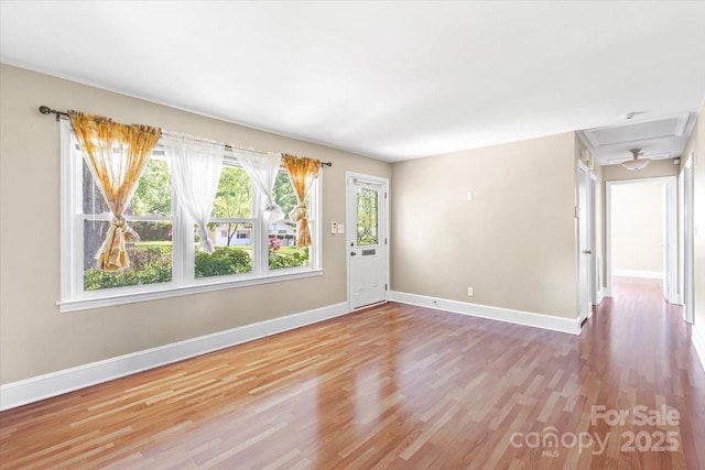 spare room with wood finished floors and baseboards