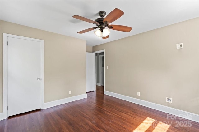 unfurnished bedroom with wood finished floors, baseboards, and a ceiling fan