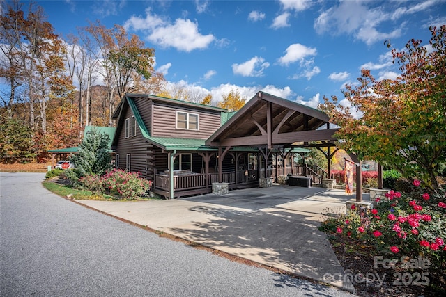 36 Destiny Trl, Maggie Valley, NC 28751 - cabin with a porch, concrete driveway, log siding, and metal roof