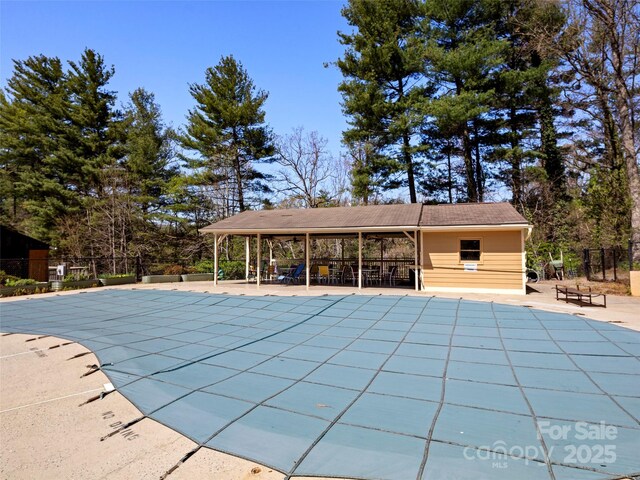 pool featuring a patio and fence