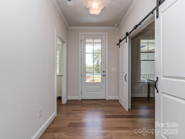 143 Robinson Ridge Dr, Mooresville, NC 28117 - doorway to outside featuring visible vents, baseboards, a barn door, ornamental molding, and wood finished floors