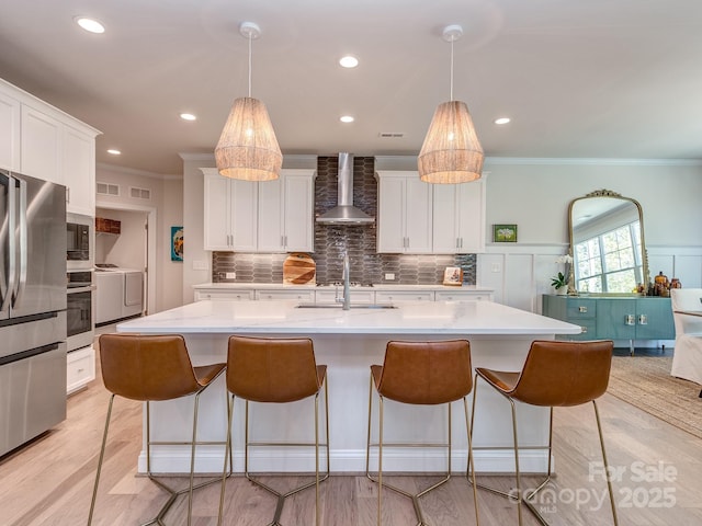 143 Robinson Ridge Dr, Mooresville, NC 28117 - kitchen featuring ornamental molding, light countertops, wall chimney exhaust hood, and stainless steel appliances