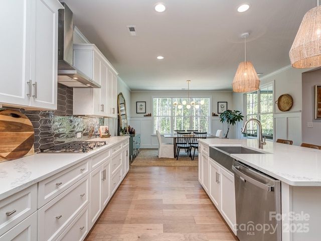 143 Robinson Ridge Dr, Mooresville, NC 28117 - kitchen with a sink, wall chimney range hood, recessed lighting, white cabinetry, and stainless steel appliances